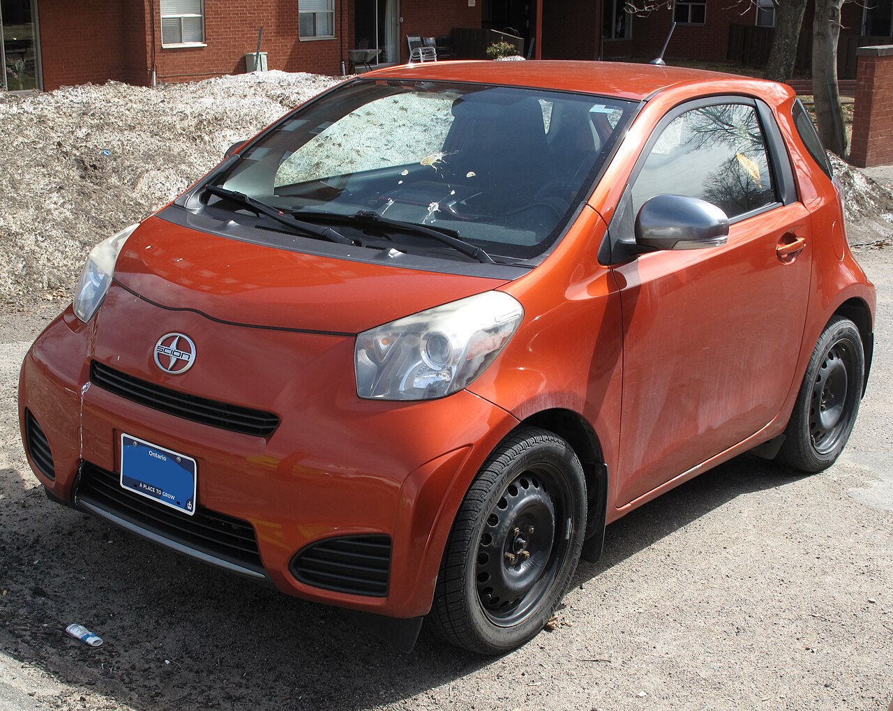 A Scion iQ in Hot Lava orange, representative of the compact platform TAZ built Haolebuilt II from